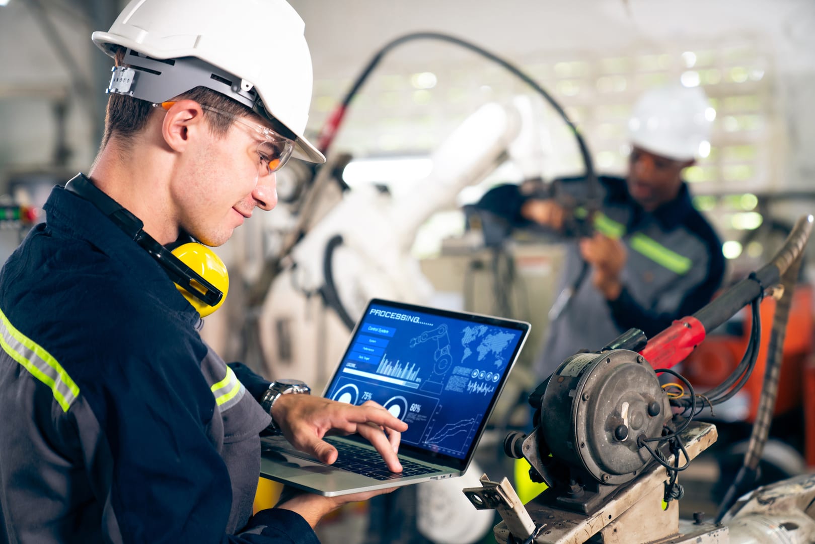 Factory worker with robotic arm